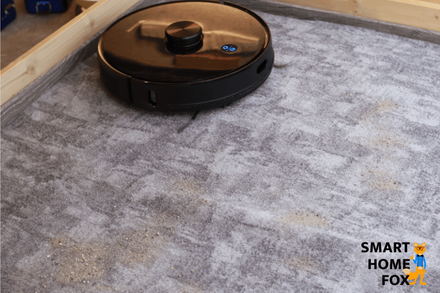 Proscenic M7 Pro собирает песок во время теста на всасывание на ковре с коротким ворсом